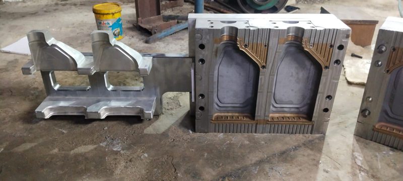 Open blow mould showing Beryllium Copper inserts at the neck and pinch-off.