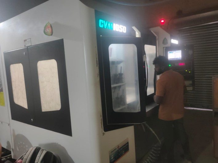 Operator at the Cosmos CVM 1050 machining centre.