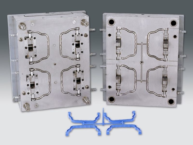 Four-cavity injection mould with the moulded components on the runner.